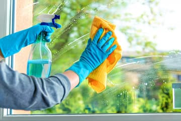 Mustang Ventures cleaning a residential window to a streak-free finish in Memorial, Houston